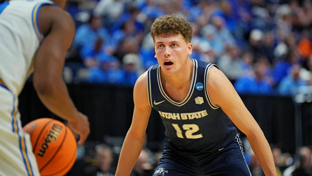 Mar 20, 2025; Lexington, KY, USA; Utah State Aggies guard Mason Falslev (12) guards UCLA Bruins guard Dylan Andrews (2) in the first round of the NCAA Tournament at Rupp Arena. Mar 20, 2025; Lexington, KY, USA; Utah State Aggies guard Mason Falslev (12) guards UCLA Bruins guard Dylan Andrews (2) in the first round of the NCAA Tournament at Rupp Arena.