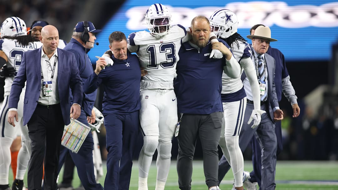 Dec 9, 2024; Arlington, Texas, USA; Dallas Cowboys linebacker DeMarvion Overshown (13) is helped off the field after an injury in the second half against the Cincinnati Bengals at AT&T Stadium. Mandatory Credit: Tim Heitman-Imagn Images