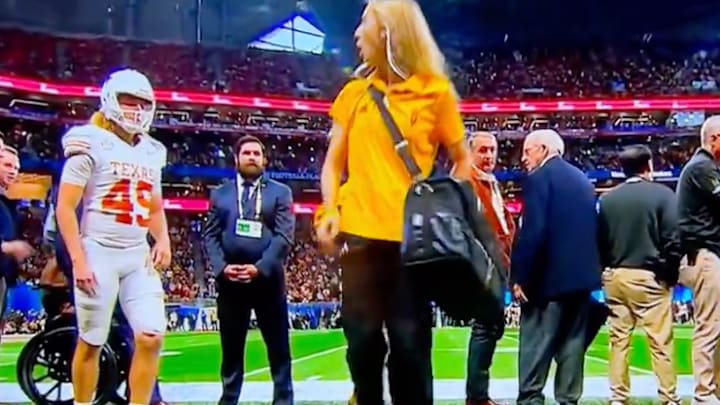 An Arizona State staffer walks past Texas kicker Bert Auburn as he warms up during the fourth quarter of the Peach Bowl vs. the Sun Devils on January 1, 2025. An Arizona State staffer walks past Texas kicker Bert Auburn as he warms up during the fourth quarter of the Peach Bowl vs. the Sun Devils on January 1, 2025.