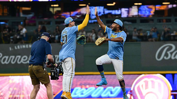 Aug 18, 2024; Milwaukee, Wisconsin, USA; Milwaukee Brewers shortstop Willy Adames (27) and left fielder Jackson Chourio (11) celebrates after beating the Cleveland Guardians at American Family Field. Mandatory Credit: Benny Sieu-Imagn Images