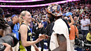 Dallas Mavericks point guard Irving talks with Dallas Wings guard Bueckers after the game against the Indiana Fever at the American Airlines Center. 