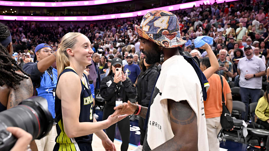 Dallas Mavericks point guard Irving talks with Dallas Wings guard Bueckers after the game against the Indiana Fever at the American Airlines Center.  | Jerome Miron-Imagn Images