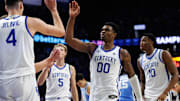 Dec 2, 2025; Lexington, Kentucky, USA; Kentucky Wildcats guard Otega Oweh (00) fives forward Andrija Jelavic (4) during the second half against the North Carolina Tar Heels at Rupp Arena at Central Bank Center. Mandatory Credit: Jordan Prather-Imagn Images