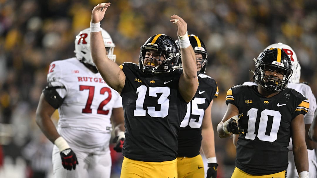 Nov 11, 2023; Iowa City, Iowa, USA; Iowa Hawkeyes defensive end Joe Evans (13) and linebacker Nick Jackson (10) react during the fourth quarter against the Rutgers Scarlet Knights at Kinnick Stadium. Mandatory Credit: Jeffrey Becker-Imagn Images