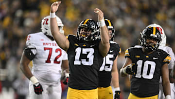 Nov 11, 2023; Iowa City, Iowa, USA; Iowa Hawkeyes defensive end Joe Evans (13) and linebacker Nick Jackson (10) react during the fourth quarter against the Rutgers Scarlet Knights at Kinnick Stadium. Mandatory Credit: Jeffrey Becker-Imagn Images