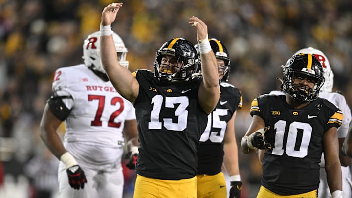 Nov 11, 2023; Iowa City, Iowa, USA; Iowa Hawkeyes defensive end Joe Evans (13) and linebacker Nick Jackson (10) react during the fourth quarter against the Rutgers Scarlet Knights at Kinnick Stadium. Mandatory Credit: Jeffrey Becker-Imagn Images