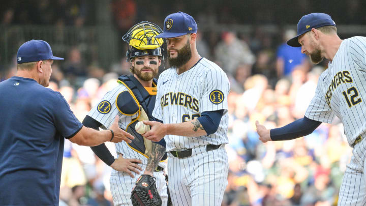 Jul 13, 2024; Milwaukee, Wisconsin, USA; Milwaukee Brewers starting pitcher Dallas Keuchel (60) hands the ball to manager Pat Murphy during a pitching change in the fourth inning against the Washington Nationals at American Family Field. Mandatory Credit: Benny Sieu-USA TODAY Sports
