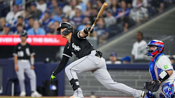 Jun 22, 2025; Toronto, Ontario, CAN; Chicago White Sox third base Miguel Vargas (20) hits a double against the Toronto Blue Jays during the eighth inning at Rogers Centre. Mandatory Credit: Kevin Sousa-Imagn Images
