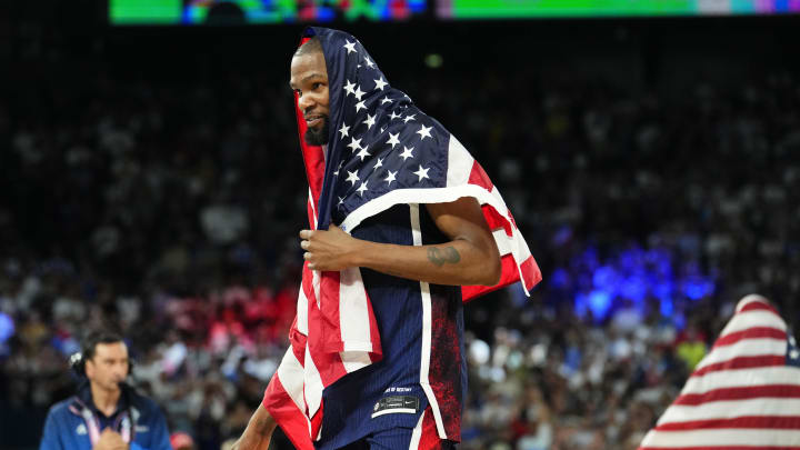 Aug 10, 2024; Paris, France; United States guard Kevin Durant (7) celebrates after defeating France in the men's basketball gold medal game during the Paris 2024 Olympic Summer Games at Accor Arena. Mandatory Credit: Rob Schumacher-USA TODAY Sports