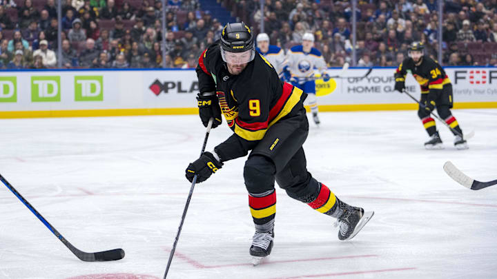 Jan 21, 2025; Vancouver, British Columbia, CAN; Vancouver Canucks forward J.T. Miller (9) handles the puck against the Buffalo Sabres in the second period at Rogers Arena. Mandatory Credit: Bob Frid-Imagn Images