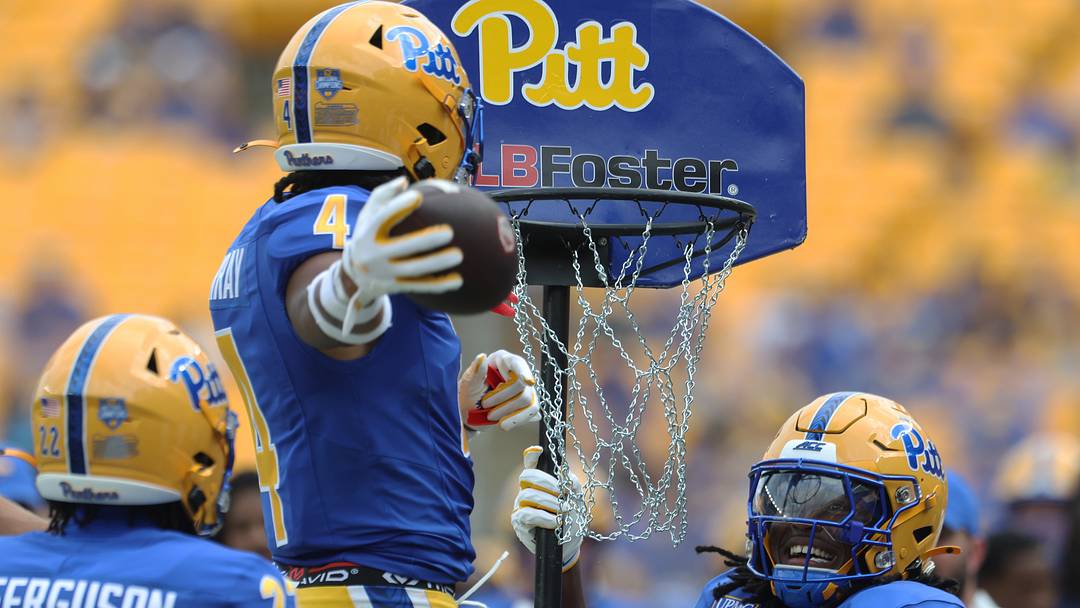 Sep 5, 2026; Pittsburgh, Pennsylvania, USA;  Pittsburgh Panthers defensive back Rashan Murray (4) dunks the football in a basketball hoop after an interception against the Miami (OH) RedHawks during the fourth quarter at Acrisure Stadium.  Mandatory Credit: Charles LeClaire-Imagn Images