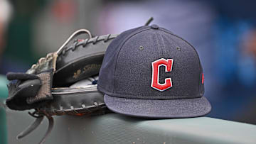 Jun 27, 2024; Kansas City, Missouri, USA; A general view a Cleveland Guardians hat and glove on the dugout railing  before a game against the Kansas City Royals at Kauffman Stadium.