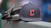Jun 27, 2024; Kansas City, Missouri, USA; A general view a Cleveland Guardians hat and glove on the dugout railing  before a game against the Kansas City Royals at Kauffman Stadium. Mandatory Credit: Peter Aiken-Imagn Images