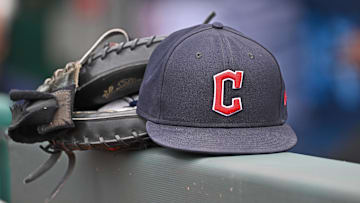 Jun 27, 2024; Kansas City, Missouri, USA; A general view a Cleveland Guardians hat and glove on the dugout railing  before a game against the Kansas City Royals at Kauffman Stadium. Mandatory Credit: Peter Aiken-Imagn Images