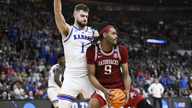Arkansas Razorbacks center Jonas Aidoo (9) controls the ball against Kansas Jayhawks center Hunter Dickinson 