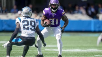 Oct 1, 2023; Charlotte, North Carolina, USA; Minnesota Vikings running back Cam Akers (31) looks to elude Carolina Panthers cornerback D'Shawn Jamison (29) during the second half at Bank of America Stadium. Mandatory Credit: Jim Dedmon-USA TODAY Sports