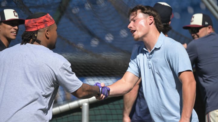 Jul 19, 2024; Cleveland, Ohio, USA; Cleveland Guardians number one draft pick Travis Bazzana, right, shakes hands with third baseman Jose Ramirez (11) before the game between the Cleveland Guardians and the San Diego Padres at Progressive Field. Mandatory Credit: Ken Blaze-USA TODAY Sports