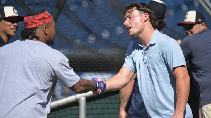 Jul 19, 2024; Cleveland, Ohio, USA; Cleveland Guardians number one draft pick Travis Bazzana, right, shakes hands with third baseman Jose Ramirez (11) before the game between the Cleveland Guardians and the San Diego Padres at Progressive Field. Mandatory Credit: Ken Blaze-Imagn Images