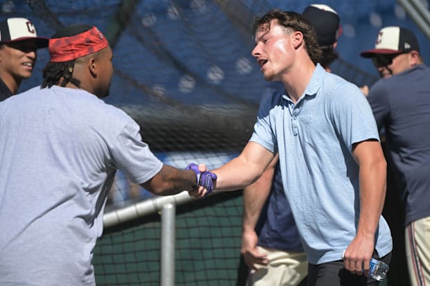 Jose Ramirez and Travis Bazzana shake hands. 