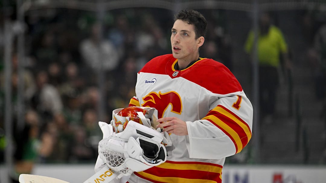 Apr 7, 2026; Dallas, Texas, USA; Calgary Flames goaltender Devin Cooley (1) skates back on the ice during the second period against the Dallas Stars at the American Airlines Center. Mandatory Credit: Jerome Miron-Imagn Images