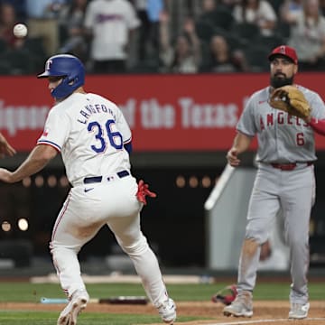 Sep 7, 2024; Arlington, Texas, USA; Texas Rangers center fielder Wyatt Langford (36) is caught in a rundown by Los Angeles Angels third baseman Anthony Rendon (6) and catcher Logan O'Hoppe (14) during the eighth inning at Globe Life Field. 