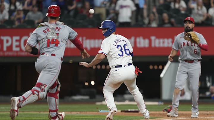 Sep 7, 2024; Arlington, Texas, USA; Texas Rangers center fielder Wyatt Langford (36) is caught in a rundown by Los Angeles Angels third baseman Anthony Rendon (6) and catcher Logan O'Hoppe (14) during the eighth inning at Globe Life Field. 