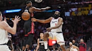 Mar 12, 2025; Miami, Florida, USA;  LA Clippers guard James Harden (1) passes the ball around Miami Heat center Bam Adebayo (13) during the first half at Kaseya Center. Mandatory Credit: Jim Rassol-Imagn Images