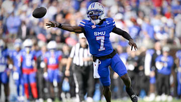Nov 22, 2025; Dallas, Texas, USA; SMU Mustangs quarterback Kevin Jennings (7) throws a shovel pass to running back T.J. Harden (not pictured) for a touchdown against the Louisville Cardinals during the first half at Gerald J. Ford Stadium. Mandatory Credit: Jerome Miron-Imagn Images