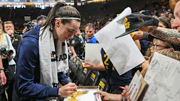 May 4, 2025; Iowa City, IA, USA; Indiana Fever guard Caitlin Clark (22) signs autographs for fans after the game against the Brazil National Team at Carver-Haweye Arena. Mandatory Credit: Jeffrey Becker-Imagn Images
