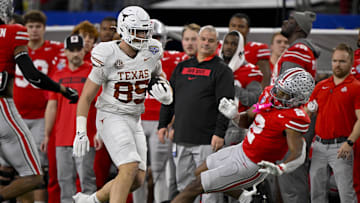 Jan 10, 2025; Arlington, TX, USA; Texas Longhorns tight end Gunnar Helm (85) shoves Ohio State Buckeyes safety Caleb Downs (2) and draws a penalty during the game between the Texas Longhorns and the Ohio State Buckeyes at AT&T Stadium. Mandatory Credit: Jerome Miron-Imagn Images