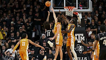 Feb 22, 2025; College Station, Texas, USA; Tennessee Volunteers forward Cade Phillips (12) blocks a shot from Texas A&M Aggies forward Andersson Garcia (11) during the second half at Reed Arena. Mandatory Credit: Maria Lysaker-Imagn Images 