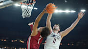Apr 6, 2024; Glendale, AZ, USA; Connecticut Huskies forward Alex Karaban (11) blocks the shot of Alabama Crimson Tide guard Mark Sears (1) during the second half in the semifinals of the men's Final Four of the 2024 NCAA Tournament at State Farm Stadium. Mandatory Credit: Bob Donnan-Imagn Images