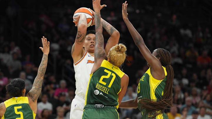 Aug 5, 2023; Phoenix, Arizona, USA; Phoenix Mercury center Brittney Griner (42) shoots over Seattle Storm forward Gabby Williams (5) and Seattle Storm center Mercedes Russell (21) and Seattle Storm center Ezi Magbegor (13) during the first half at Footprint Center. Mandatory Credit: Joe Camporeale-Imagn Images