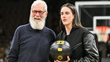 Feb 2, 2025; Iowa City, Iowa, USA; Former Iowa Hawkeyes player Caitlin Clark and comedian David Letterman react after the game at Carver-Hawkeye Arena against the USC Trojans. The Hawkeyes retired the jersey of Clark after the game. Mandatory Credit: Jeffrey Becker-Imagn Images