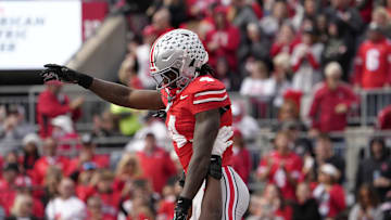 Nov 9, 2024; Columbus, Ohio, USA; Ohio State Buckeyes wide receiver Jeremiah Smith (4) is hoisted in the air by Ohio State Buckeyes offensive lineman Tegra Tshabola (77) after scoring a touchdown during the first half  at Ohio Stadium. Mandatory Credit: Barbara Perenic/USA TODAY Network via Imagn Images