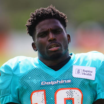 Hill looks on during Dolphins practice.