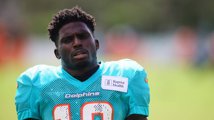 Hill looks on during Dolphins practice.