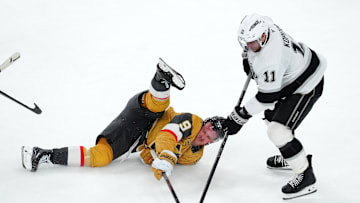 Mar 9, 2025; Las Vegas, Nevada, USA; Los Angeles Kings center Anze Kopitar (11) takes the puck from a fallen Vegas Golden Knights center Jack Eichel (9) during the third period at T-Mobile Arena. Mandatory Credit: Stephen R. Sylvanie-Imagn Images
