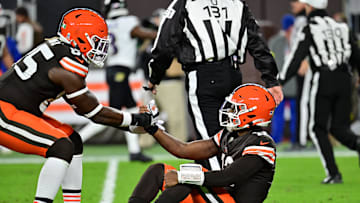 Nov 16, 2025; Cleveland, Ohio, USA; Cleveland Browns tight end David Njoku (85) helps up quarterback Shedeur Sanders (12) following a thrown interception during the third quarter against the Baltimore Ravens at Huntington Bank Field. Mandatory Credit: Ken Blaze-Imagn Images
