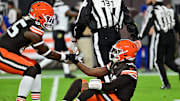 Nov 16, 2025; Cleveland, Ohio, USA; Cleveland Browns tight end David Njoku (85) helps up quarterback Shedeur Sanders (12) following a thrown interception during the third quarter against the Baltimore Ravens at Huntington Bank Field. Mandatory Credit: Ken Blaze-Imagn Images