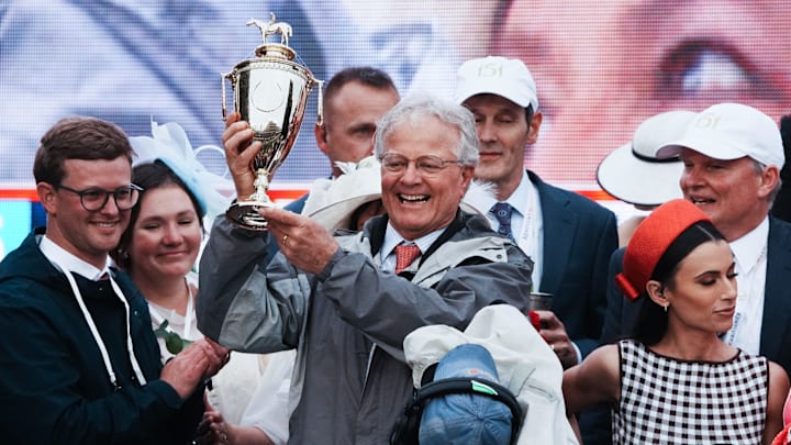Trainer Bill Mott celebrated with the trophy in the winner's circle after jockey Junior Alvarado rode Sovereignty to victory in the Kentucky Derby.