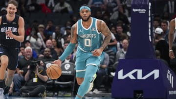 Apr 5, 2024; Charlotte, North Carolina, USA; Charlotte Hornets forward Miles Bridges (0) brings the ball up court against the Orlando Magic during the second half at Spectrum Center. Mandatory Credit: Jim Dedmon-USA TODAY Sports