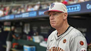 San Francisco Giants third base coach Matt Williams shown in the dugout wearing the team’s Fourth of July cap before the game against the Atlanta Braves at Truist Park. 