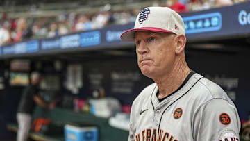 San Francisco Giants third base coach Matt Williams shown in the dugout wearing the team’s Fourth of July cap before the game against the Atlanta Braves at Truist Park. 