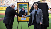 Jul 7, 2022; San Diego, California, USA; San Diego Padres former radio announcer and team ambassador Ted Leitner (left) shakes hands with Padres chairman Peter Seidler after being inducted into the Padres hall of fame before the game against the San Francisco Giants at Petco Park. Mandatory Credit: Orlando Ramirez-Imagn Images