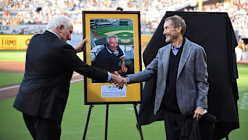 Jul 7, 2022; San Diego, California, USA; San Diego Padres former radio announcer and team ambassador Ted Leitner (left) shakes hands with Padres chairman Peter Seidler after being inducted into the Padres hall of fame before the game against the San Francisco Giants at Petco Park. Mandatory Credit: Orlando Ramirez-Imagn Images