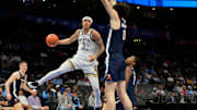 Mar 12, 2025; Charlotte, NC, USA; Georgia Tech Yellow Jackets guard Naithan George (1) passes the ball as Virginia Cavaliers forward Blake Buchanan (0) defends in the first half at Spectrum Center. Mandatory Credit: Bob Donnan-Imagn Images