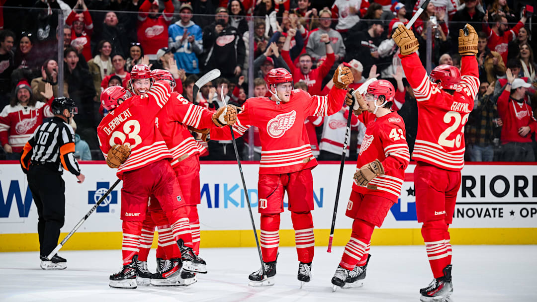 Dec 21, 2025; Detroit, Michigan, USA; Detroit Red Wings defenseman Moritz Seider (53) celebrates his game winning goal with teammates during overtime against the Washington Capitals at Little Caesars Arena. Mandatory Credit: Tim Fuller-Imagn Images