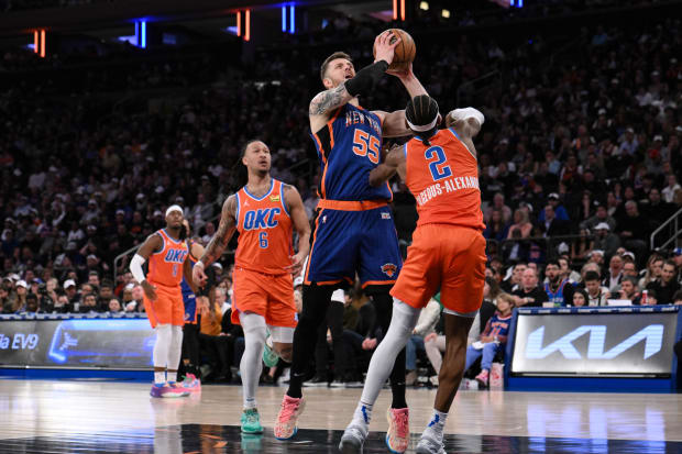 Mar 31, 2024; New York, New York, USA; New York Knicks center Isaiah Hartenstein (55) shoots the ball while being defended by Oklahoma City Thunder guard Shai Gilgeous-Alexander (2) during the second quarter at Madison Square Garden. Mandatory Credit: John Jones-USA TODAY Sports