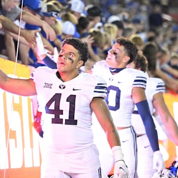 Sep 6, 2024; Dallas, Texas, USA; Brigham Young Cougars linebacker Sione Moa (41) slaps hands with the fans after the Cougars win over the Southern Methodist Mustangs at Gerald J. Ford Stadium. Mandatory Credit: Jerome Miron-Imagn Images